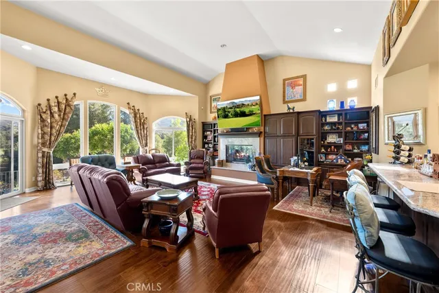 a living room with furniture fireplace and a large window