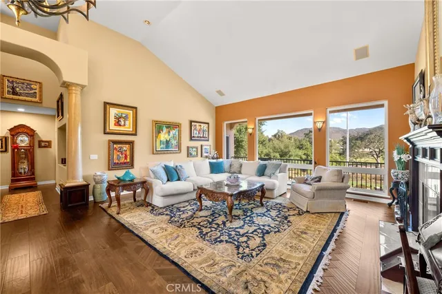 a living room with furniture a fireplace and a large window