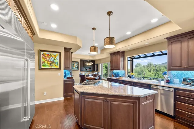 a kitchen with a sink a counter top space stainless steel appliances and a window