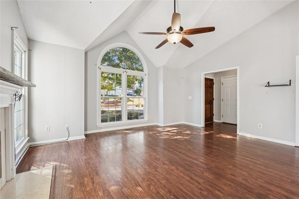 2470 Jakin Way Suwanee, GA 30024 - Photo 11 of 64 an empty room with wooden floor fan and windows