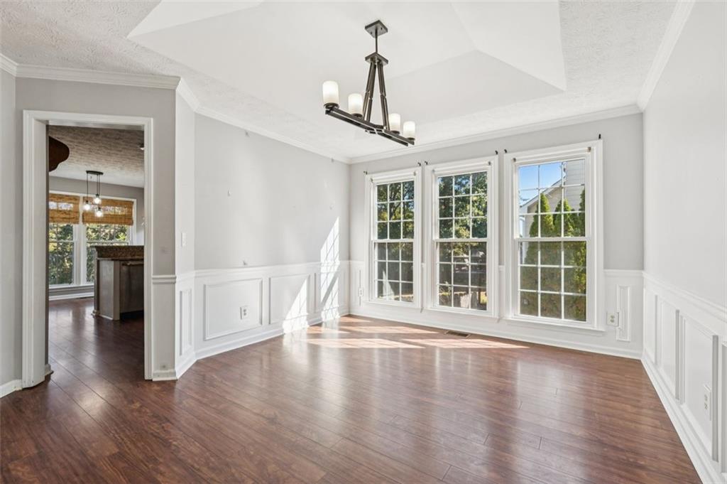2470 Jakin Way Suwanee, GA 30024 - Photo 13 of 64 a view of an empty room with wooden floor and a window