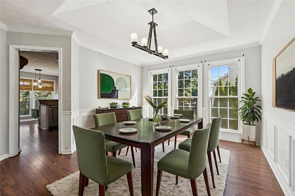 2470 Jakin Way Suwanee, GA 30024 - Photo 14 of 64 a view of a dining room with furniture window and wooden floor