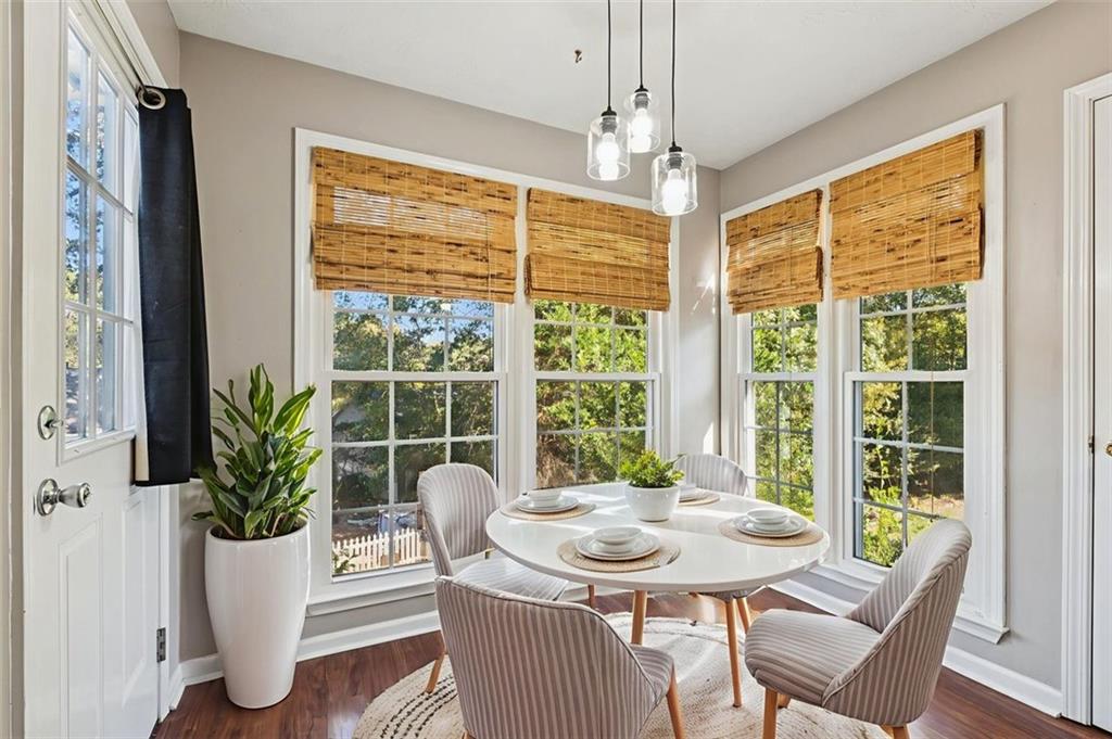 2470 Jakin Way Suwanee, GA 30024 - Photo 20 of 64 a view of a dining room with furniture window and wooden floor