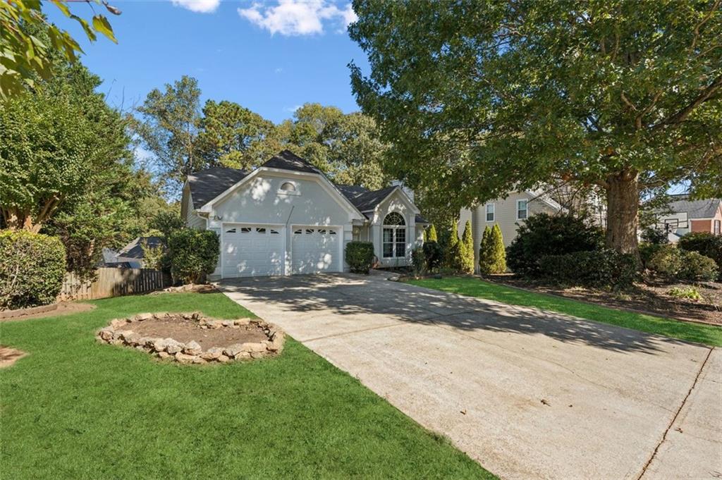 2470 Jakin Way Suwanee, GA 30024 - Photo 2 of 64 a front view of a house with a garden