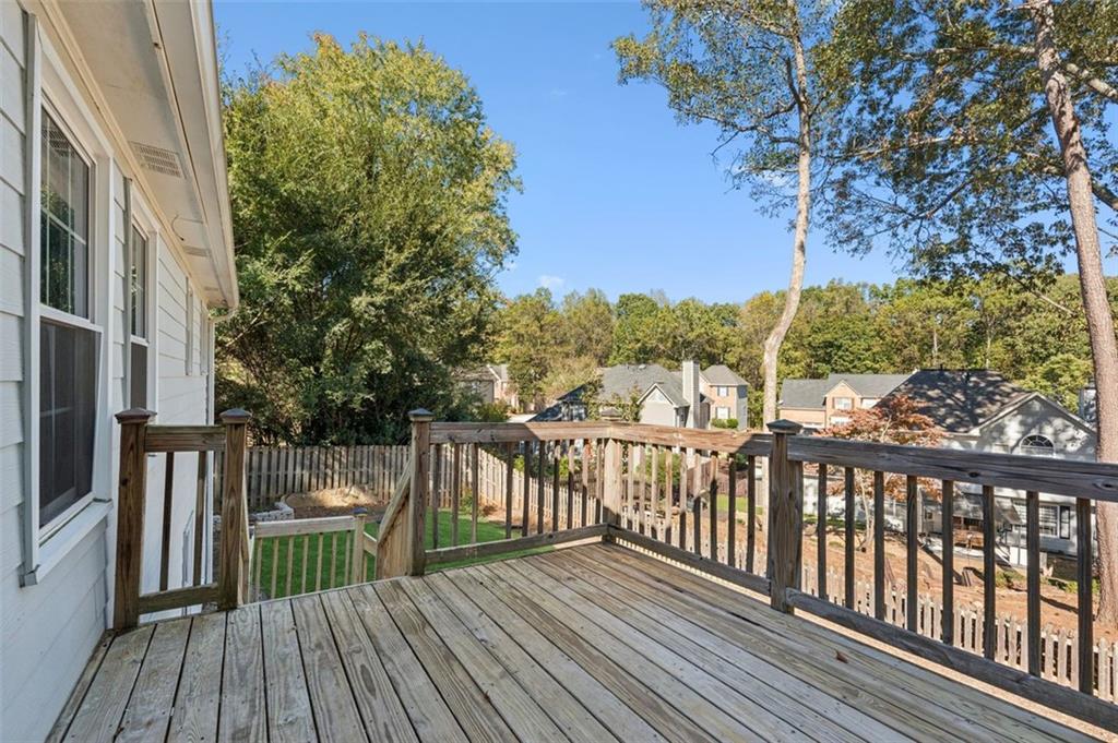 2470 Jakin Way Suwanee, GA 30024 - Photo 21 of 64 a view of a balcony with wooden floor and fence