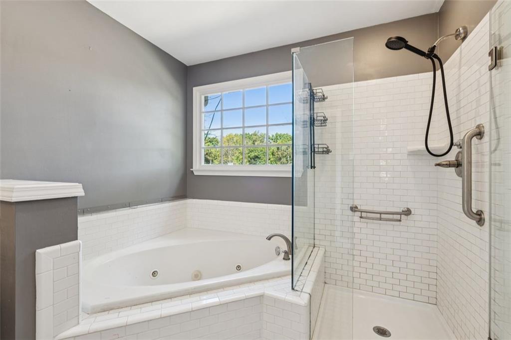 2470 Jakin Way Suwanee, GA 30024 - Photo 26 of 64 a bathroom with a bath tub and a shower