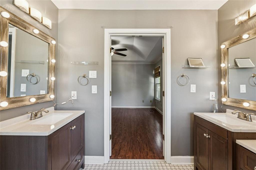 2470 Jakin Way Suwanee, GA 30024 - Photo 27 of 64 a bathroom with a sink a shower and a mirror