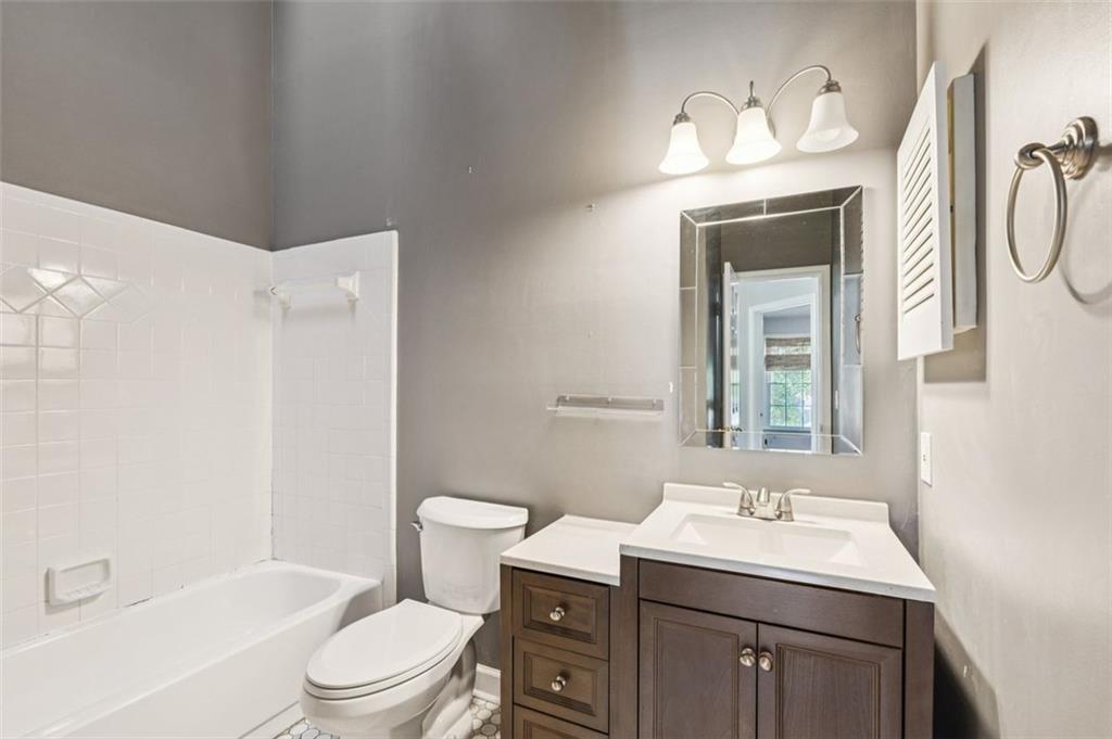 2470 Jakin Way Suwanee, GA 30024 - Photo 31 of 64 a bathroom with a granite countertop sink toilet and shower