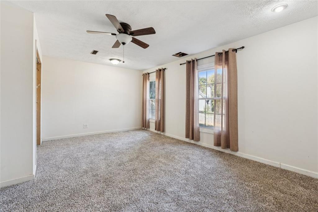 2470 Jakin Way Suwanee, GA 30024 - Photo 33 of 64 a view of an empty room with a ceiling fan