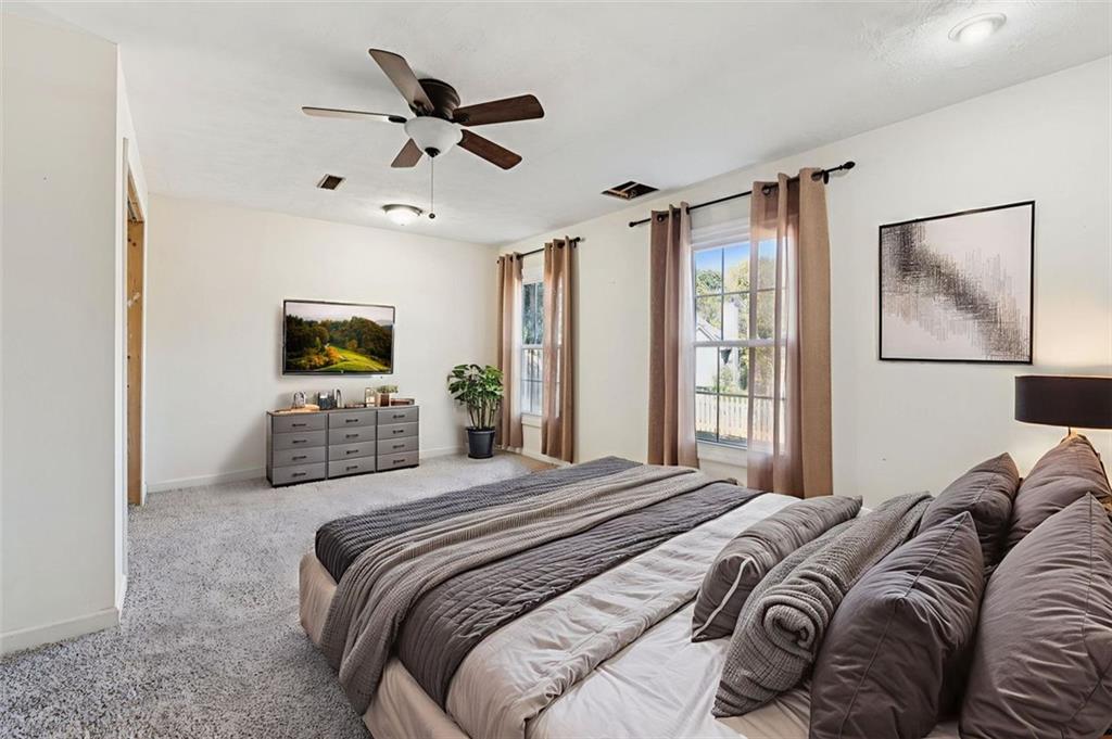 2470 Jakin Way Suwanee, GA 30024 - Photo 34 of 64 a bedroom with a bed window and flat screen tv