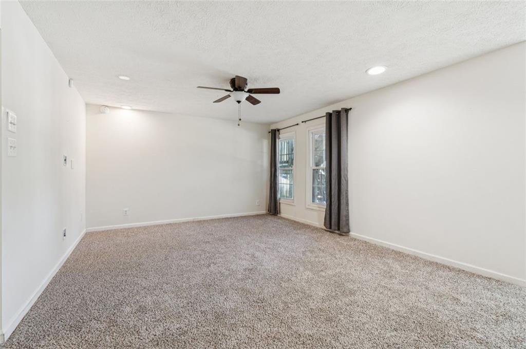 2470 Jakin Way Suwanee, GA 30024 - Photo 37 of 64 a view of an empty room with a ceiling fan