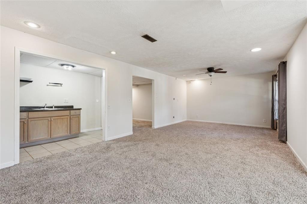 2470 Jakin Way Suwanee, GA 30024 - Photo 39 of 64 a view of an empty room with a kitchen