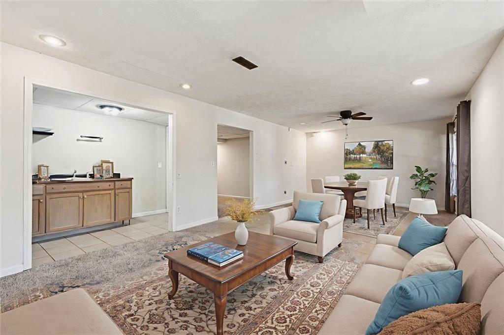 2470 Jakin Way Suwanee, GA 30024 - Photo 40 of 64 a living room with furniture and view of kitchen