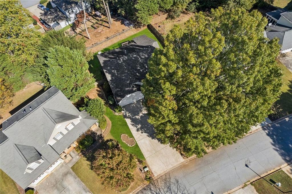 2470 Jakin Way Suwanee, GA 30024 - Photo 4 of 64 an aerial view of a house with a yard and trees