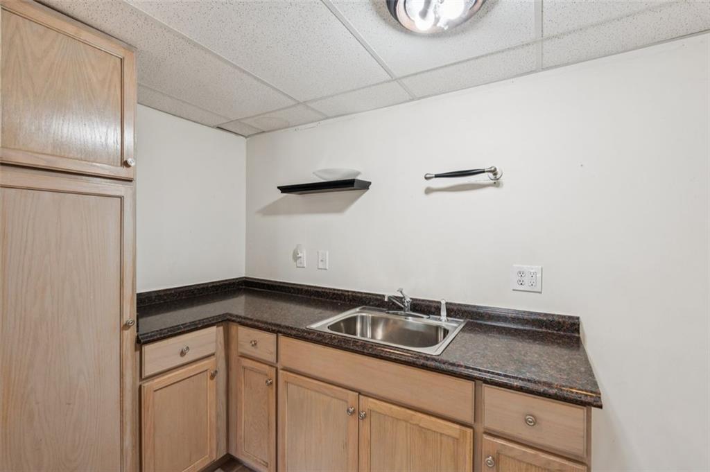 2470 Jakin Way Suwanee, GA 30024 - Photo 41 of 64 a kitchen with a sink and cabinets