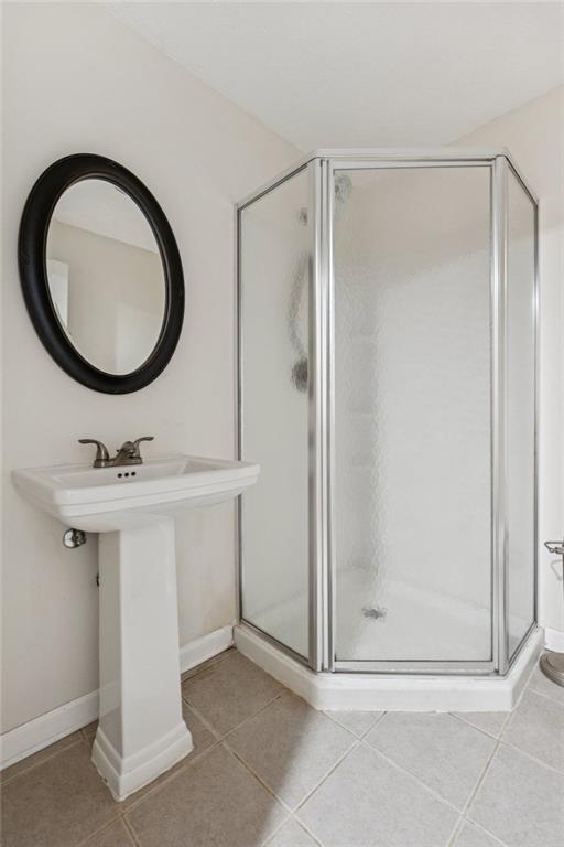 2470 Jakin Way Suwanee, GA 30024 - Photo 45 of 64 a bathroom with a sink a mirror a shower and a mirror