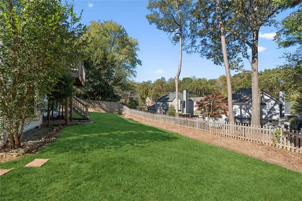 2470 Jakin Way Suwanee, GA 30024 - Photo 48 of 64 a view of yard with swimming pool and trees