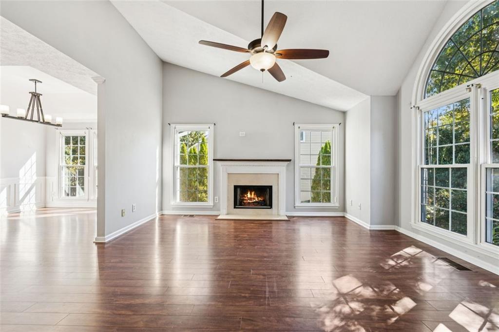 2470 Jakin Way Suwanee, GA 30024 - Photo 8 of 64 a view of an empty room with wooden floor and a window