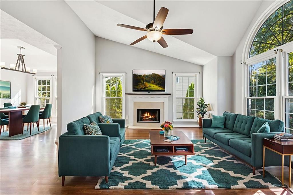 2470 Jakin Way Suwanee, GA 30024 - Photo 9 of 64 a living room with furniture a fireplace and a flat screen tv