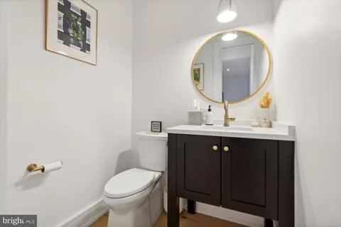 a bathroom with a toilet a sink and mirror