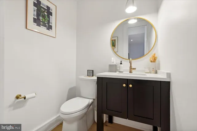 a bathroom with a toilet a sink and mirror