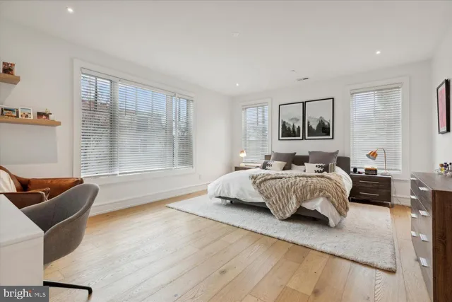 a bedroom with a bed and glass window