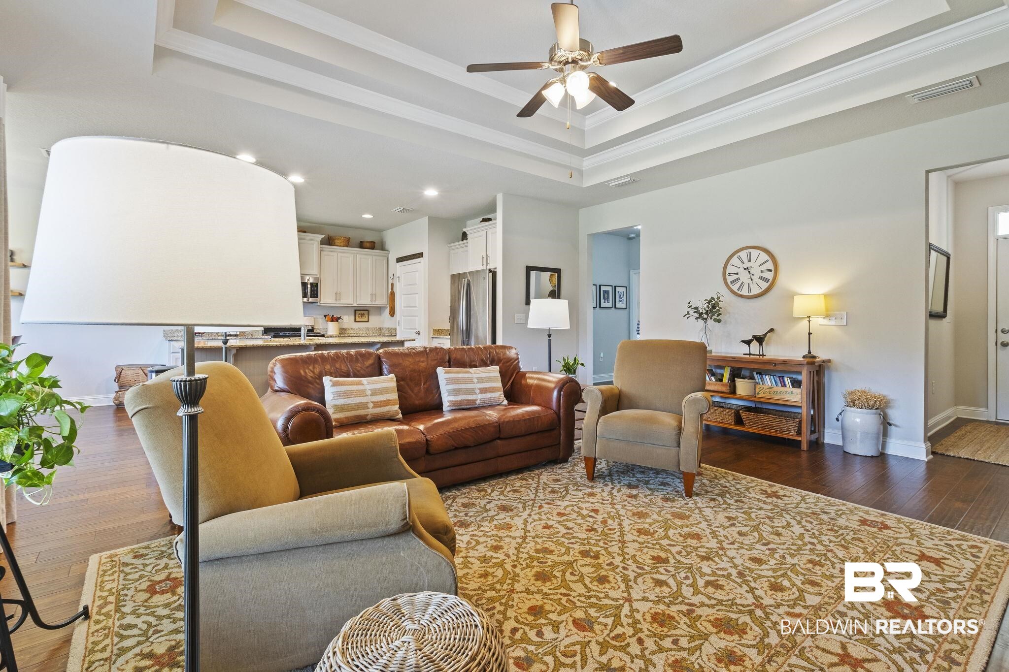 31663 Kestrel Loop Daphne, AL 36527 - Photo 19 of 86 Living room featuring crown molding, ceiling fan, a tray ceiling, and hardwood / wood-style flooring