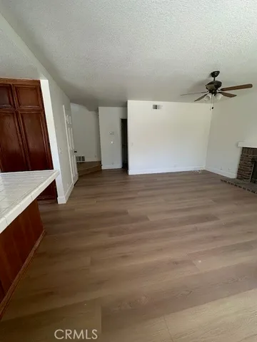 a view of a room with wooden floor