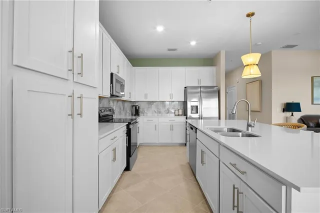 a kitchen with kitchen island white cabinets and white appliances
