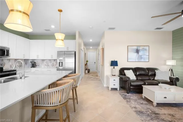 a living room with a couch and a chandelier