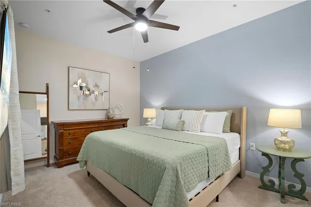 a bedroom with a bed and a lamp on table