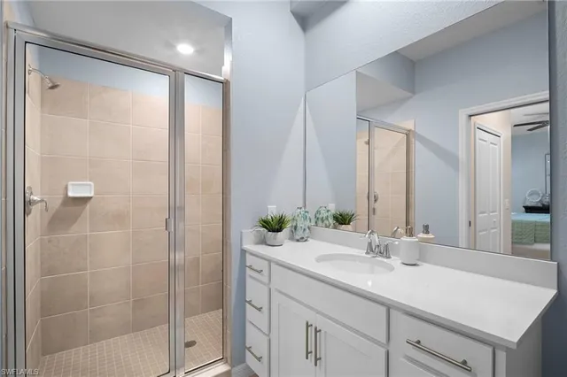 a bathroom with a shower sink and mirror
