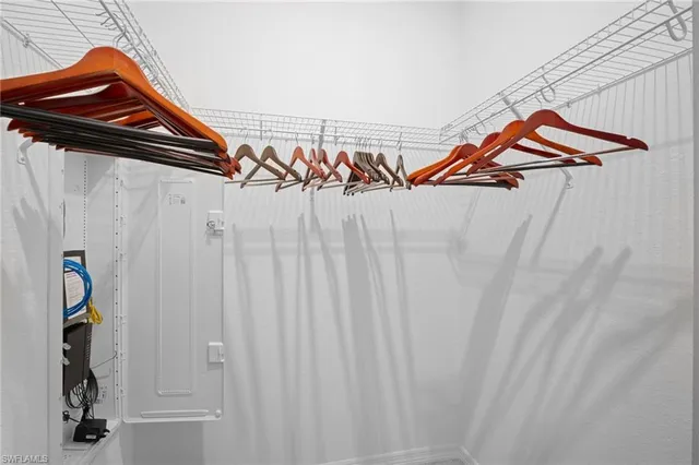 a view of a closet with wooden floor