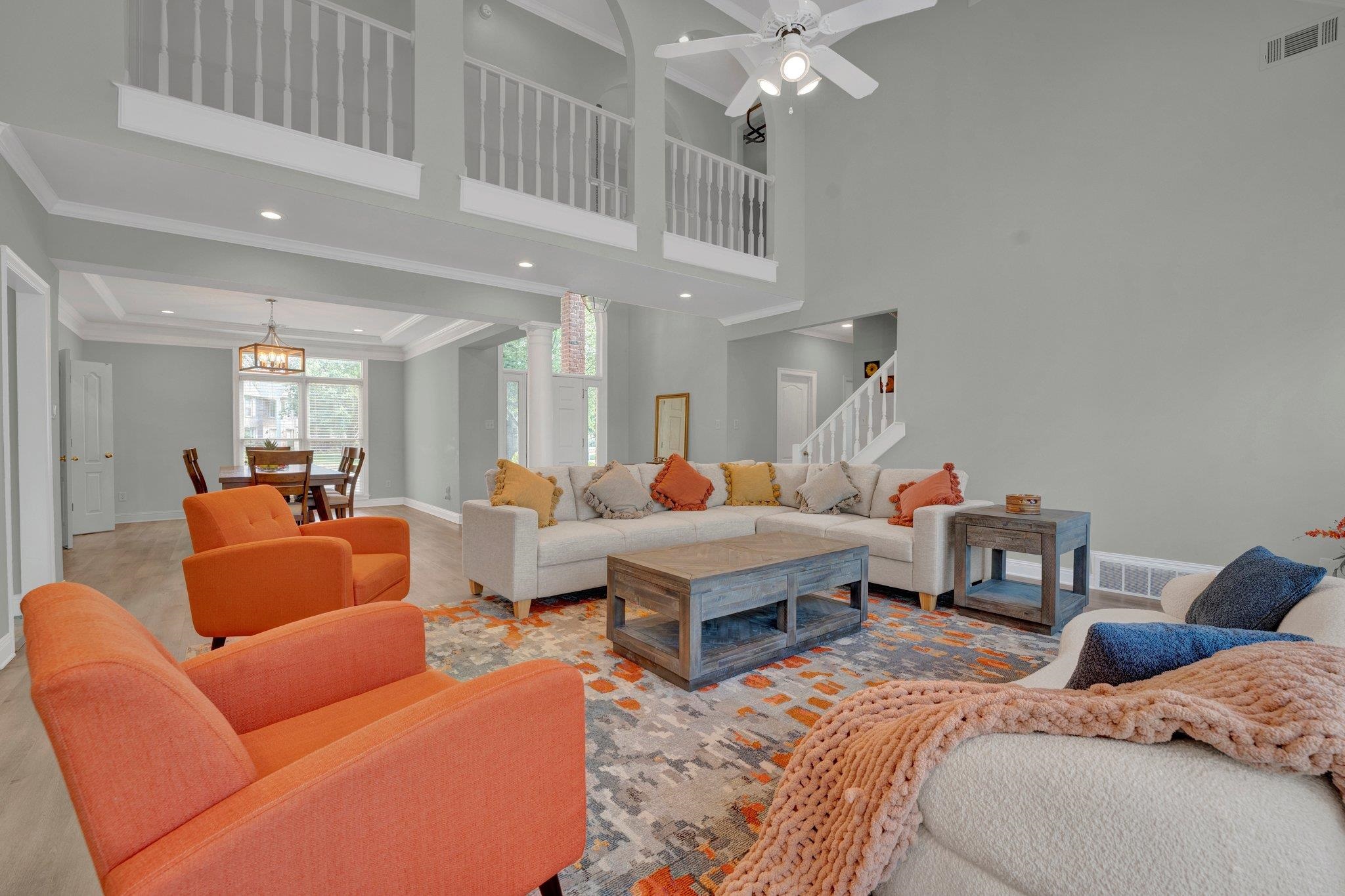 1331 Riding Brook Drive Collierville, TN 38017 - Photo 4 of 39 Living room featuring ornamental molding, ceiling fan with notable chandelier, and a high ceiling