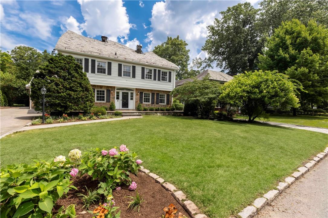 9 Kingston Road Scarsdale, NY 10583 - Photo 1 of 1 a front view of a house with a yard and trees