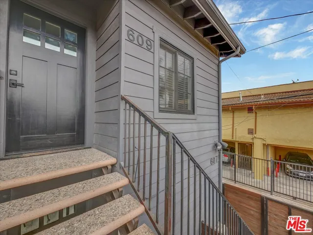 a view of a room with wooden floor and windows