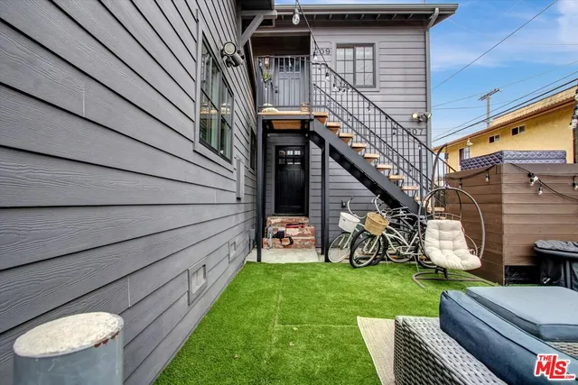 a view of a patio with a white table and chairs