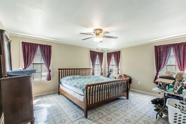 a bedroom with a bed and windows