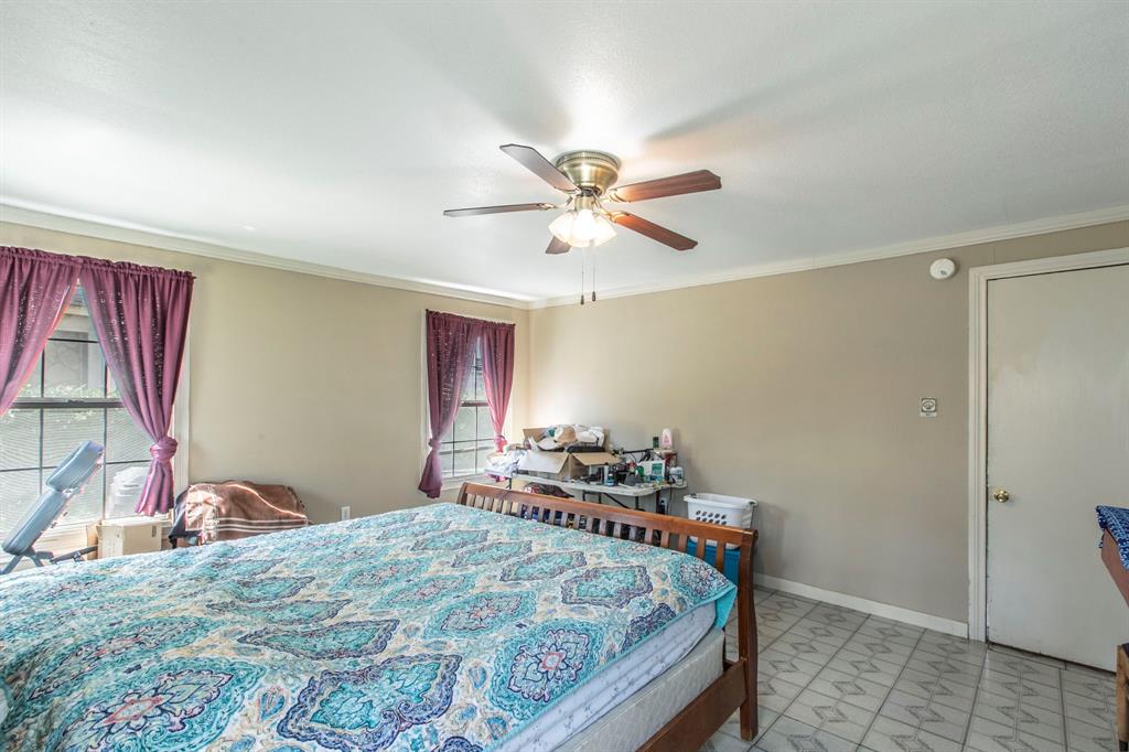 2101 Pine Avenue Waco, TX 76708 - Photo 12 of 27 a bedroom with a bed and a chandelier