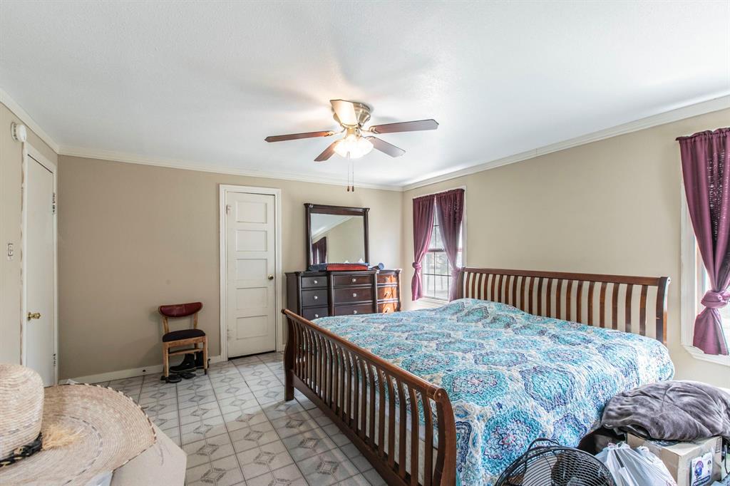 2101 Pine Avenue Waco, TX 76708 - Photo 13 of 27 a bedroom with a bed and a chandelier