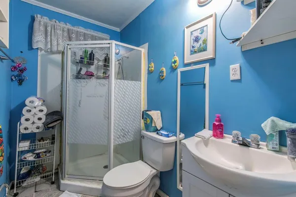 a white toilet sitting next to a bathroom sink