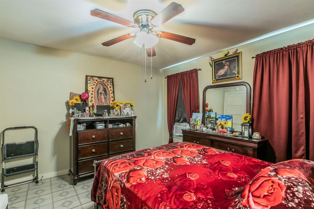2101 Pine Avenue Waco, TX 76708 - Photo 17 of 27 a bedroom with a bed and a dresser in it