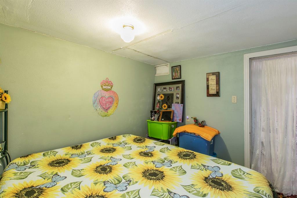 2101 Pine Avenue Waco, TX 76708 - Photo 19 of 27 a bedroom with a bed and painting on the wall