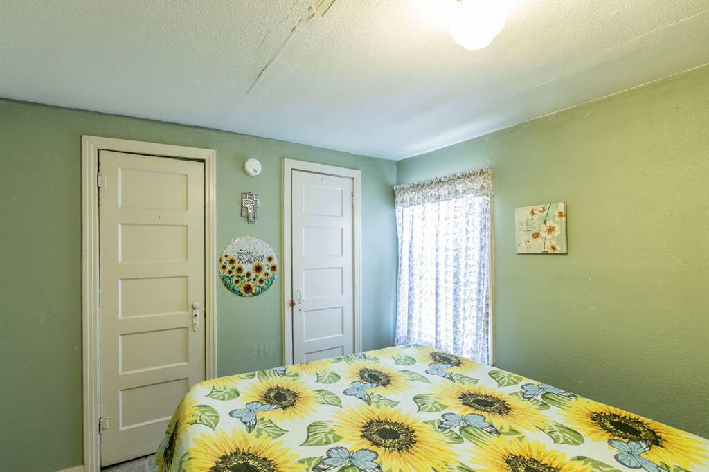 2101 Pine Avenue Waco, TX 76708 - Photo 20 of 27 a bedroom with a bed and painting on the wall