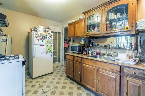 a kitchen with refrigerator and cabinets