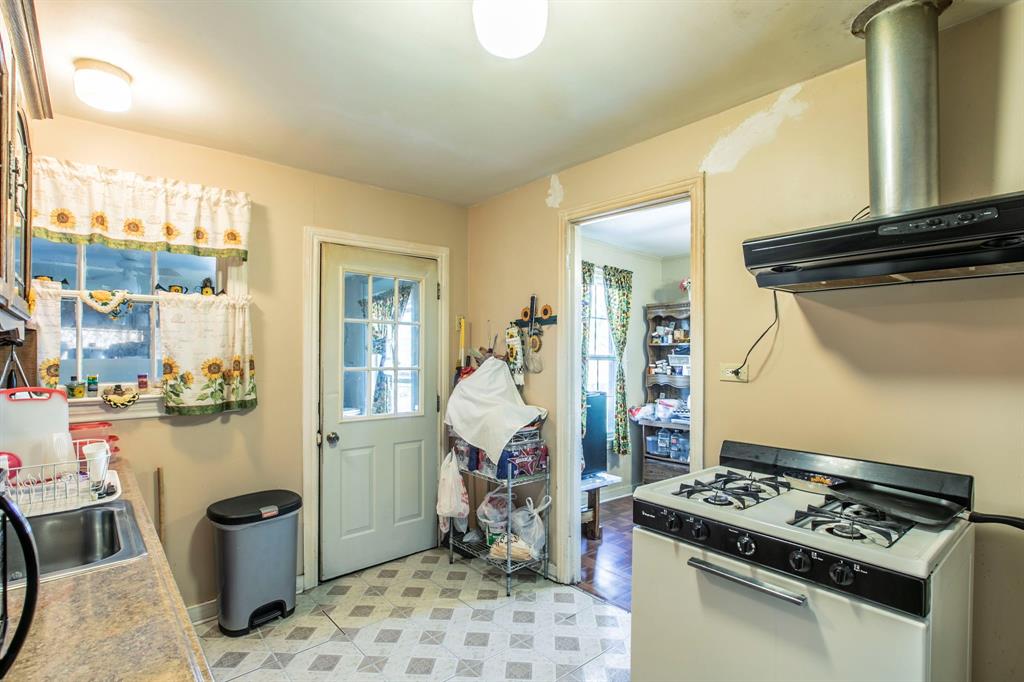 2101 Pine Avenue Waco, TX 76708 - Photo 7 of 27 a kitchen with a stove and a wooden cabinets