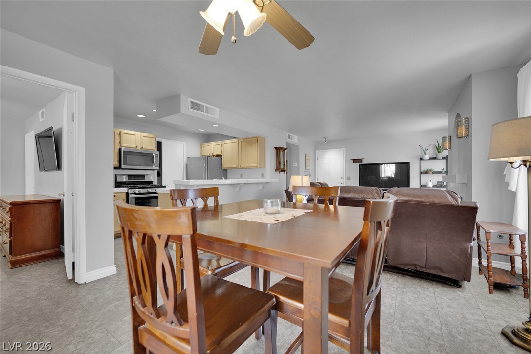 7570 West Flamingo Road, Unit 115 Las Vegas, NV 89147 - Photo 33 of 34 An open floorplan seamlessly connects the dining and living spaces, creating an inviting atmosphere.