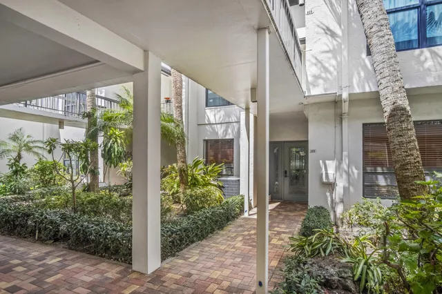 a front view of a house with outdoor seating and plants