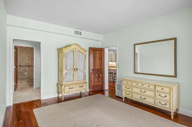 a bedroom with a baby crib and a dresser