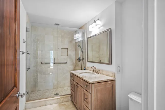 a bathroom with a sink a toilet and shower